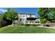 Backyard featuring a green lawn, deck with shade, and trees at 5049 Heatherglen Dr, Highlands Ranch, CO 80130