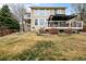 Charming home backyard featuring a covered patio, lush lawn and beautiful landscaping at 5049 Heatherglen Dr, Highlands Ranch, CO 80130