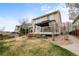 This backyard has a covered patio with outdoor furniture, nice landscaping and a walkway at 5049 Heatherglen Dr, Highlands Ranch, CO 80130