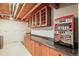 Basement featuring a countertop, storage cabinets, unfinished ceilings and a vintage gaming machine at 5049 Heatherglen Dr, Highlands Ranch, CO 80130