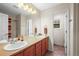 Bright bathroom features a double sink vanity and a shower with updated fixtures and neutral accents at 5049 Heatherglen Dr, Highlands Ranch, CO 80130
