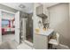 Bathroom featuring a shower with glass door, vanity and stool with a view to the main bedroom at 5049 Heatherglen Dr, Highlands Ranch, CO 80130