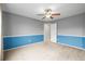 Bedroom features neutral carpet, two-tone paint, a ceiling fan and an access door to the rest of the home at 5049 Heatherglen Dr, Highlands Ranch, CO 80130