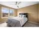 Bedroom with neutral carpet, modern ceiling fan, a window with a view and a queen size bed at 5049 Heatherglen Dr, Highlands Ranch, CO 80130