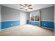 Spacious bedroom with neutral carpet, gray and blue painted walls and a ceiling fan and natural light at 5049 Heatherglen Dr, Highlands Ranch, CO 80130