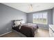 Stylish bedroom with natural light, modern ceiling fan, and neutral decor at 5049 Heatherglen Dr, Highlands Ranch, CO 80130