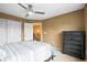 Bedroom features neutral carpet, a modern ceiling fan, and an access door to the rest of the home at 5049 Heatherglen Dr, Highlands Ranch, CO 80130