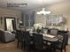 Elegant dining room showcases a long table with seating for eight, bathed in natural light from the window at 5049 Heatherglen Dr, Highlands Ranch, CO 80130