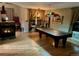 Spacious game room features a pool table, fireplace, and a wet bar area, perfect for entertaining guests at 5049 Heatherglen Dr, Highlands Ranch, CO 80130