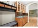 Hallway with a wet bar, granite countertop, cabinets, and a seating area at 5049 Heatherglen Dr, Highlands Ranch, CO 80130