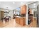 Open-concept kitchen with a dining area and an adjacent living room featuring large windows at 5049 Heatherglen Dr, Highlands Ranch, CO 80130
