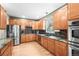 Modern kitchen with stainless steel appliances, mosaic backsplash, and abundant cabinet space at 5049 Heatherglen Dr, Highlands Ranch, CO 80130