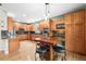 Spacious kitchen with stainless steel appliances, wood cabinetry, granite countertops, and a center island at 5049 Heatherglen Dr, Highlands Ranch, CO 80130