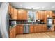 Well-lit kitchen with stainless steel appliances, granite countertops, and ample cabinet storage at 5049 Heatherglen Dr, Highlands Ranch, CO 80130