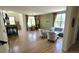Bright living room with fireplace, hardwood floors, and large windows offering natural light at 5049 Heatherglen Dr, Highlands Ranch, CO 80130