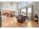 Open-concept living and kitchen area with lots of natural light and hardwood floors at 5049 Heatherglen Dr, Highlands Ranch, CO 80130