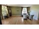 Comfortable living room with hardwood floors, stylish furniture, and plenty of natural light from large windows at 5049 Heatherglen Dr, Highlands Ranch, CO 80130