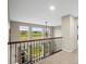 Bright loft with large windows overlooking a green landscape and decorative railings at 5049 Heatherglen Dr, Highlands Ranch, CO 80130