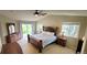 Spacious main bedroom featuring a vaulted ceiling, large bed, and natural light from windows and sliding glass door at 5049 Heatherglen Dr, Highlands Ranch, CO 80130