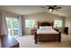 Bright main bedroom with vaulted ceiling, large bed, and access to a balcony through sliding glass doors at 5049 Heatherglen Dr, Highlands Ranch, CO 80130