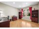 Home office with hardwood floors, natural light, and built-in bookshelves at 5049 Heatherglen Dr, Highlands Ranch, CO 80130