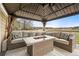Cozy outdoor space featuring a fire pit table with comfortable seating and a protective gazebo at 5049 Heatherglen Dr, Highlands Ranch, CO 80130