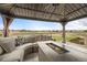 Outdoor space features a fire table and plush seating with a scenic green view at 5049 Heatherglen Dr, Highlands Ranch, CO 80130
