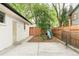 Cozy backyard with concrete patio, wooden fence, and a playground area featuring a slide and swing set for Gathering enjoyment at 6891 W Eldorado Pl, Lakewood, CO 80227