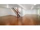 Spacious finished basement with hardwood flooring and staircase at 6891 W Eldorado Pl, Lakewood, CO 80227