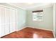 Bedroom with hardwood floors, a closet, and a window at 6891 W Eldorado Pl, Lakewood, CO 80227