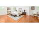 Bright bedroom with hardwood floors, a cozy rug, bench and a neutral color palette and decorative lamps at 6891 W Eldorado Pl, Lakewood, CO 80227