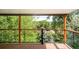 The deck has wood floors and railings, surrounded by lush greenery and beautiful views of the landscape at 6891 W Eldorado Pl, Lakewood, CO 80227