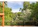 The deck offers lush views of the surrounding landscape with mature trees creating a sense of privacy at 6891 W Eldorado Pl, Lakewood, CO 80227