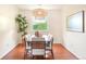 Elegant dining room featuring a modern chandelier and a large window with natural light at 6891 W Eldorado Pl, Lakewood, CO 80227