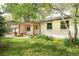 Inviting front yard with lush green grass and colorful landscaping, leading to the charming front entrance at 6891 W Eldorado Pl, Lakewood, CO 80227