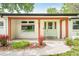 Close-up of the front porch showing the address, vibrant green door, and freshly landscaped flower beds at 6891 W Eldorado Pl, Lakewood, CO 80227