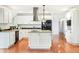 Modern kitchen with stainless steel appliances, granite countertops, and white cabinets at 6891 W Eldorado Pl, Lakewood, CO 80227