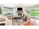 Open-concept living area featuring a fireplace, modern furniture, and access to an outdoor deck at 6891 W Eldorado Pl, Lakewood, CO 80227