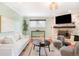 Cozy living room features a fireplace, hardwood floors, and neutral-toned furniture at 6891 W Eldorado Pl, Lakewood, CO 80227