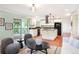 Cozy living space with an open layout connecting the kitchen, living area, and outdoor deck at 6891 W Eldorado Pl, Lakewood, CO 80227