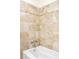 Shower with tile walls and a bathtub features neutral tones at 6891 W Eldorado Pl, Lakewood, CO 80227