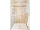 Shower with tile walls and a sliding glass door features neutral tones at 6891 W Eldorado Pl, Lakewood, CO 80227