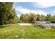 Landscaped sand volleyball court featuring picnic tables, benches and mature trees enhancing outdoor recreation at 6891 W Eldorado Pl, Lakewood, CO 80227