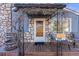 Charming front door with stone facade, covered porch and seating, creating a welcoming entrance at 709 2Nd St, Golden, CO 80403