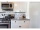 Modern kitchen with stainless steel appliances and white cabinets with dark hardware at 709 2Nd St, Golden, CO 80403