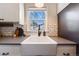 Close up view of a bright white farmhouse sink in a kitchen with white subway tile at 709 2Nd St, Golden, CO 80403