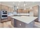 Gourmet kitchen featuring a large island with quartz countertops and modern cabinetry at 1765 Peak Loop, Broomfield, CO 80023