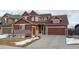 Two-story house with brown siding, brick accents, and a two-car garage at 4067 S Odessa St, Aurora, CO 80013