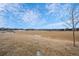 Large open grassy field with distant homes and blue sky at 4067 S Odessa St, Aurora, CO 80013