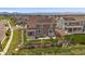 Back aerial view of home with solar panels, well-maintained yard, and views of the mountains at 848 Sandstone Cir, Erie, CO 80516